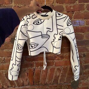 White long-sleeve face pattern crop top